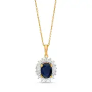 Oval Blue Sapphire and 0.2 CT. T.W. Baguette and Round Natural Diamond Starburst Frame Pendant in 10K Yellow Gold