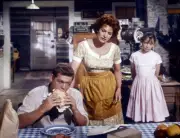 James MacArthur eats as Maureen O Hara looks over him in spencers - Old Photo