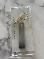 NWT Rodan and Fields gray leather & gold metal signature R&F charm key chain