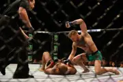 Conor McGregor punches Jose Aldo at UFC 194, 2015 12x8 Photo