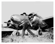AMELIA EARHART AVIATOR IN FRONT OF PLANE 8X10 PHOTO