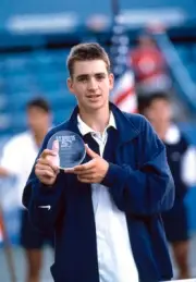 Nicolas Kiefer of Germany poses with the trophy after defeating Ul- Old Photo
