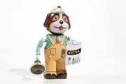 Dog With Newspaper And Bell Tin Toy