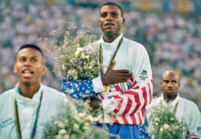 Carl Lewis USA stands on the podium and sings the national anthem - Old Photo