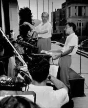 Singer Frank Sinatra rendering a song as conductor Max Steiner- 1940s Photo 4