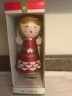 Angel tree topper gold glitter hair red and white body small ding in the skirt