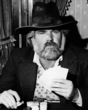 Kenny Rogers holds up his cards sitting at poker table The Gambler Poster
