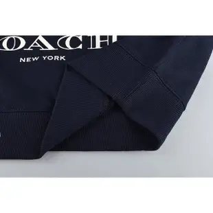 【COACH】COACH Peanuts Snoopy字母LOGO聯名款史努比抱糊塗塌客聖誕燈棉圓領長袖T恤(女款/海軍藍)