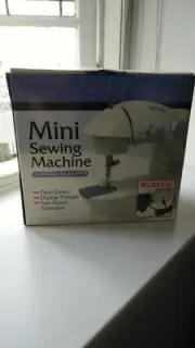 BNIB Mini sewing machine with AD/DC adapter