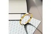 Carrie Stainless Steel Bangle in Gold - 64mm