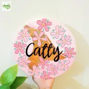 Custom Hand-Painted Wooden Name Board – Floral Design – 11-Inch Diameter