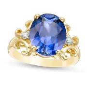 Oval Lab-Created Blue Sapphire and 0.05 CT. T.W. Diamond Scroll Frame Ring in Solid 10K Yellow Gold