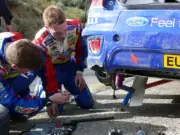 Jari Matti Latvala and Miikka Anttila make some temporary repairs - 2008 Photo