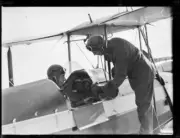 Frank Follatt talking to H.T. Hammond in the cockpit of a plane, N- Old Photo