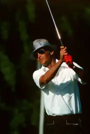 Golfer Juan Chi Chi Rodriguez swings and watches the flight of Golf 1988 Photo 2