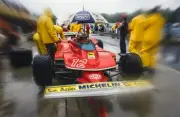 Gilles Villeneuve keeps dry in the pit lane whilst sat in his Ferr- Old Photo