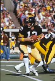 Quarterback Terry Bradshaw Pittsburgh Steelers turns to hand the - 1976 Photo 5