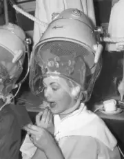 Model Susan Livesey retouching lipstick underneath hairdryer In- 1959 Old Photo