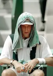 Greg Rusedski of Great Britain takes a break from the heat during - Old Photo