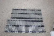 Twenty Three Pieces of O Scale Gauge, Black Ties, Tubular 10-inch Straight Track