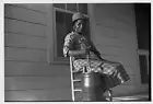 Photo:Gertrude, churning on Isaiah Pettway's porch, Gees Bend, Alabama
