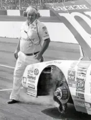 Car owner Junior Johnson checks out the damage to his Budweiser sto- Old Photo