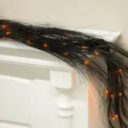 72" Aritificial Wispy Black Pine Glitter Garland with Orange Lights