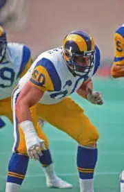 Offensive lineman Dennis Harrah of the Los Angeles Rams blocks a- 1984 Old Photo