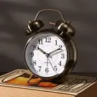 Elegant Copper and Bronze Alarm Clock with Illuminated Face for Nighttime Use