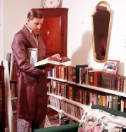 British TV presenter Judith Chalmer+s husband Neil reading a book - Old Photo