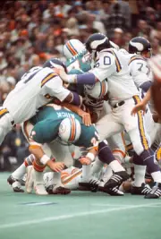 Larry Csonka Miami Dolphins gets tackled by Jeff Siemon and Carl - 1974 Photo