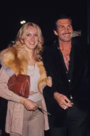 Alana Hamilton wearing a beige cardigan over a white top with a fu- Old Photo 1
