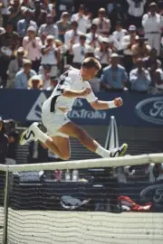 Czech tennis player Petr Korda jumping over the net in celebration- Old Photo