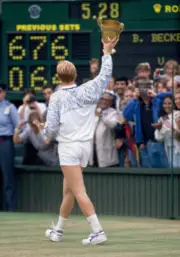 Boris Becker of West Germany salutes the crowd with the trophy fo - Old Photo