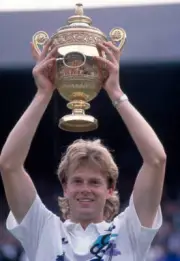 Stefan Edberg of Sweden lifts the trophy after defeating Boris Be - Old Photo