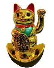 Golden Asian Lucky Beckoning Cat Sitting On A Lucky Ingot Waving His Left Paw