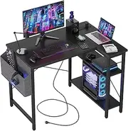 TIQLAB Small L Shaped Desk with Power Outlets - 100x70 cm Corner Computer Desk Writing Table, Reversible Large Storage Shelves, Bookshelf Workstation for Study Play Work Bedroom Home Office, Black