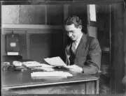 Alfred Watson Secretary of the Trades Hall sitting at his desk rea- Old Photo