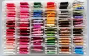 EMBROIDERY THREADS on bobbins, Varied colours, 108 approx. Complete with box.