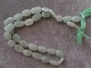 Natural green Jadeite Bead Strands, Flat oval bead, Varied cut bead sizes.