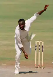 Winston Benjamin bowling for the West Indies during the Champ- Old Cricket Photo