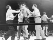 Billy Conn is helped to his feet by his handlers after 13th-round .. Old Photo