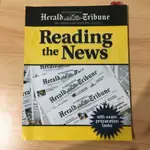 READING THE NEWS - NEW YORK TIMES INTERNATIONAL EDITION