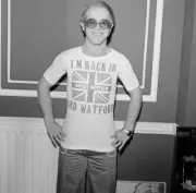 Elton John returns from America to announce that he is back in Bri- Old Photo