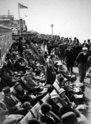Holidaymakers lying sunbeds enjoy sun Good Friday by sea April 14 - 1933 Photo