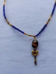 beaded necklace blue and gold with leather strings small pendant glass bead