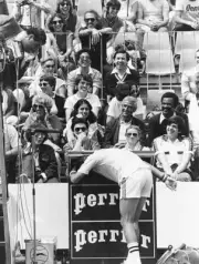 Romanian tennis player Ilie Nastase entertains the crowds by putt - Old Photo