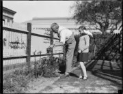 Colonel George Somerville watering a gardening display with his da- Old Photo
