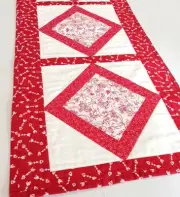 Red and White Quilted Cherubs Table Runner with White Hearts and Arrows Border