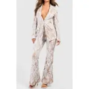 Boohoo women’s tan and ivory sequined pant suit. Blazer and flare pants size 10